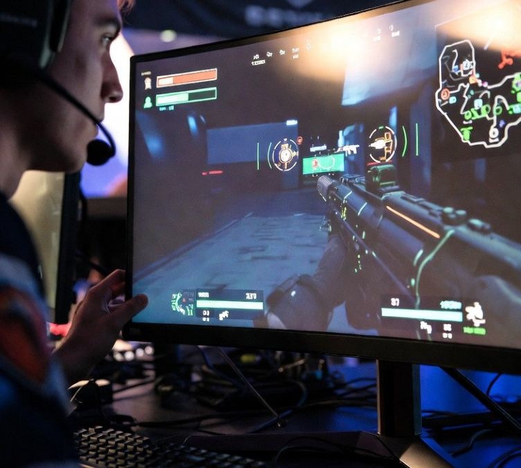 esports player adjusting monitor settings and HUD layout